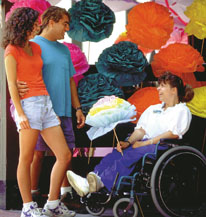 woman in wheelchair among paper flowers